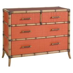 an orange dresser with bamboo handles and drawers