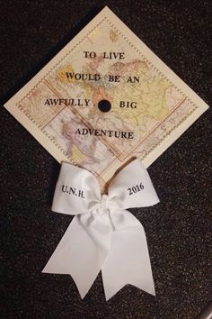 a graduation cap with the words to live would be an awfully big adventure