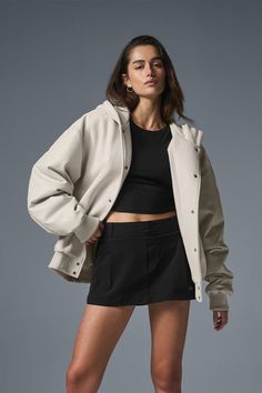 Everybody needs a bomber jacket—especially one like this, that can go from street to sleek in the blink of an eye. It has a slightly oversized fit that hits at the high hip with a heavyweight French terry body and lightly filled faux leather sleeves. The ribbed hem and cuffs keep cold air out, and it’s finished with matte snaps, side pockets and a wind-defying hood. Grab yours and get ready to wear it on repeat. Oversized Hooded Urban Varsity Jacket, Alo Yoga Long Sleeve Outerwear With Ribbed Cuffs, Sporty Cropped Jacket For Winter Streetwear, Hooded Alo Yoga Outerwear With Ribbed Cuffs, Casual Oversized Outerwear With Ribbed Collar, Alo Yoga Relaxed Fit Long Sleeve Outerwear, Alo Yoga Long Sleeve Relaxed Fit Outerwear, Oversized Hooded Varsity Jacket With Pockets, Oversized Outerwear With Ribbed Collar