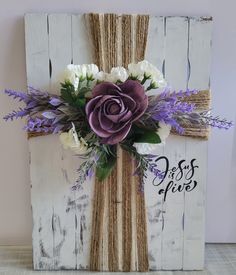 a cross made out of wood with flowers on it