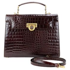 Rare Gianni Versace bag in leather color Burgundy, gold hardware. Can be carried by hand or crossbody, one of Lady Diana's favorite handbag model. Condition: Good, slight imperfections on leather on the bag interior, not visible when worn. Packing/accessories: Original strap. Measurements: 31cm x 24cm x 10cm Brown Briefcase With Gold-tone Hardware For Office, Formal Gold Satchel With Top Carry Handle, Gold Office Bag With Top Carry Handle, Formal Satchel Shoulder Bag With Gold-tone Hardware, Brown Satchel Briefcase With Gold-tone Hardware, Brown Flap Bag With Gold-tone Hardware For Business, Gold Satchel With Gold-tone Hardware, Business Brown Flap Bag With Gold-tone Hardware, Brown Top Handle Box Bag With Gold-tone Hardware