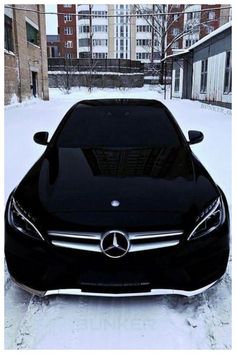 a black car is parked in the snow