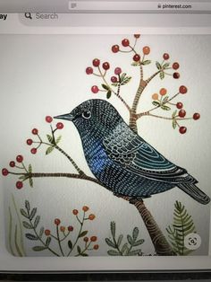 a blue bird sitting on top of a tree branch with berries and leaves painted on it