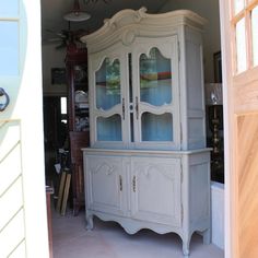 an old china cabinet is painted white