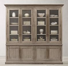 a large bookcase with glass doors and shelves