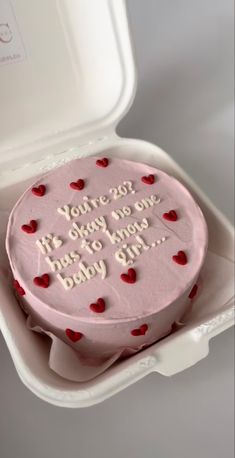 a pink cake in a white box with red hearts on it that says, you're my baby one day to be born