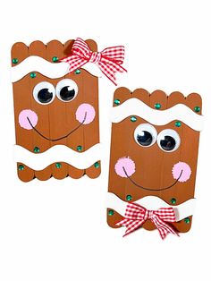 two cardboard gingerbreads with googly eyes and a bow