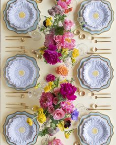 a table with plates and flowers on it