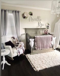 a baby's room with a crib, chair and rug