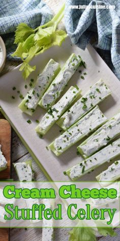 cream cheese stuffed celery on a cutting board with lettuce and dip