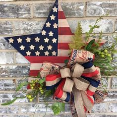 an american flag wreath hanging on a brick wall