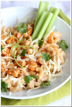 a white plate topped with noodles and celery