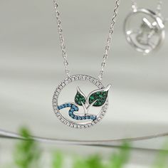 Inspired by the nature and crafted in sterling silver, this necklace features a stone-studded tree and river design. The circular pendant symbolizes the eternal cycle of life, while the river and the tree represent growth, resilience, and connection to the natural world. Crafted with meticulous attention to detail, this necklace showcases the perfect harmony between elegance and the essence of nature. Wear this enchanting piece as a reminder to embrace the ever-changing flow of life, and find co Unique Sterling Silver Tree Of Life Necklace, Nature-inspired Round Necklace For Anniversary, Nature-inspired Tree Of Life Round Jewelry, Nature-inspired Round Anniversary Necklace, Nature-inspired Round Anniversary Necklaces, Nature-inspired Birthstone Pendant Necklace, Lauren Anderson, River Design, Flow Of Life