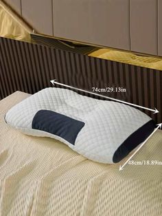 an image of a pillow that has been placed on the bed with measurements for it