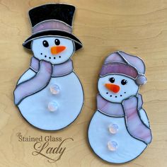 two stained glass snowmen with hats and scarves