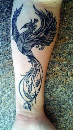 a woman's foot with a bird tattoo on the side of her leg,