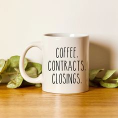 a coffee mug with the words coffee contacts closings on it next to some leaves