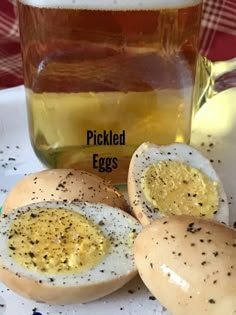 pickled eggs on a plate next to a jar of honey