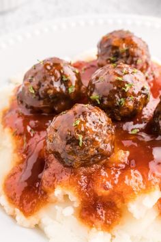 meatballs and gravy on top of mashed potatoes