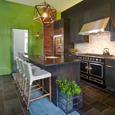 a kitchen with green walls and an island