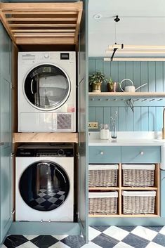 a washer and dryer in a small room with blue walls, black and white checkered flooring