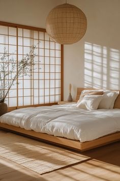 Japandi bedroom with low platform bed, shoji screens, and DIY art project embodying simplicity and natural beauty