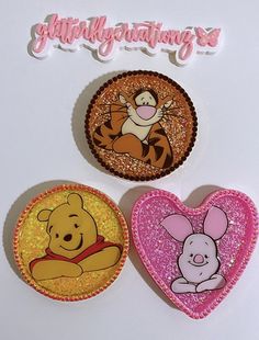 three winnie the pooh and tigger magnets on a white surface with happy birthday lettering