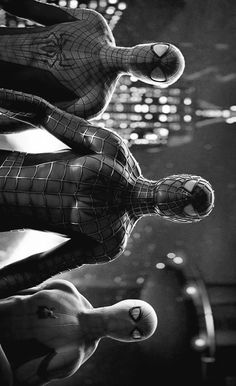 black and white photograph of spider - man statues