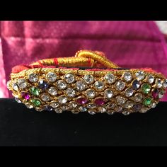 Flexible Gold Woven Thread Mesh Studded With Multicolored Stones With Velvet Back Traditional Design To Add That Extra Sparkle To Your Wrist . New Piece - Never Worn . Elegant Multicolor Festive Bracelets, Elegant Multicolor Bracelets For Festive Season, Jeweled Bracelets For Festivals, Jeweled Bracelets For Party And Festivals, Adjustable Multicolor Bracelets For Festive Season, Festive Multicolor Adjustable Bracelets, Bollywood Style Multicolor Bracelets For Celebration, Multicolor Bracelets For Formal Festivals, Multicolor Bracelets For Festivals And Formal Occasions