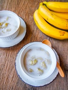 two bowls of oatmeal with bananas on the side