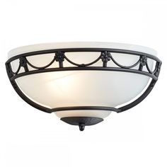 a light fixture with an iron frame and white glass shade on the top of it