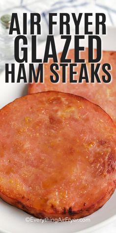 two cooked ham steaks on a white plate with text overlay that reads air fryer glazed ham steaks