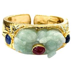 Bochic "Orient” Ruby, Sapphires & Mint Jade Vintage Cuff Set In 18 K Gold & Silver Natural Cabochon Ruby - 6 carats Blue color sapphires - 5.00 carats Vintage Jade from China Mint green Rabbit shape carving for good luck This Bangle is from the "Orient" traveling collection and it is the epitome of elegance and versatility. The Bangle offers a perfect blend for day to night and swimwear to evening wear, allowing you to effortlessly transition between different occasions and outfits. Wearing this Bangle will undoubtedly make you the center of attention. The Bangle adds a touch of glamour and sophistication to your favorite caftans, swimwear, or evening attire, enhancing your overall look. The "Orient" collection, from which this Bangle originates, showcases exceptional craftsmanship and inc Luxury Unique Cabochon Bracelets, Rabbit Shape, Ancient Jewels, Green Rabbit, Cabochon Ruby, Jade Bangle, Jade Bracelet, Jewelry Lookbook, Evening Wear