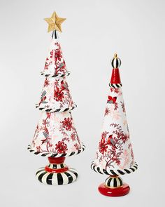 two ceramic christmas trees sitting next to each other