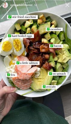 a person holding a bowl with different types of food in it