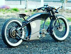 an electric bike is parked on the gravel