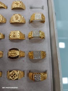 an assortment of gold and diamond rings in a display case at a jewelery shop