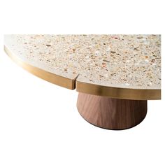 an oval marble table with brass accents