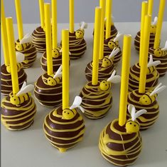 chocolate covered candies with yellow candles in the shape of bees