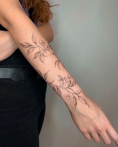 a woman with a flower tattoo on her arm