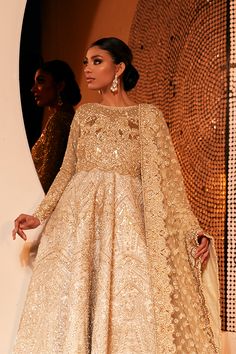 Golden Lehenga Gown for Pakistani Bridal Wear is Much like its name, Reign is stunning bridal with a regal aura. The dress is elaborately decorated with intricate hand embellishments in zardozi and marori detailing. Paired with an enchanting, heavily embroidered tulle dupatta, this ensemble becomes the perfect choice for a walima or engagement. Bridal Gown: Pakistani Bridal Dresses is introducing the walima outfit for the happiest bride. Starting the outfit with an astonishing blouse with attach Golden Lehenga, Bridal Dupatta, Lehenga Gown, Pakistani Bridal Dresses, Pakistani Bridal Wear, Beauty Clothes, Pakistani Bridal, Gown Dress, Fancy Outfits