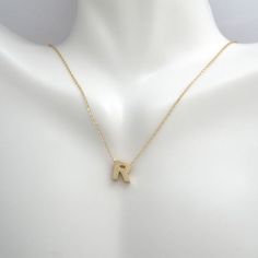 This pendant necklace is crafted in 14 Karat yellow gold. Featuring the letter "R" on a adjustable necklace measuring 16 or 18 inches in length. R Necklace, R Letter, Initial R, The Letter R, Letter R, Letter Pendants, Adjustable Necklace, Simple Necklace, Initial Necklace