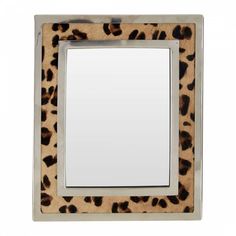 a leopard print frame with a mirror on the bottom and an empty white square in the middle