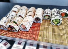 sushi rolls are arranged on a bamboo mat