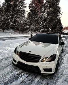 a white car is parked in the snow