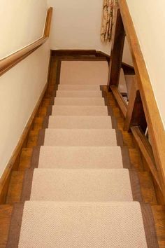 the stairs are lined with carpet and wood