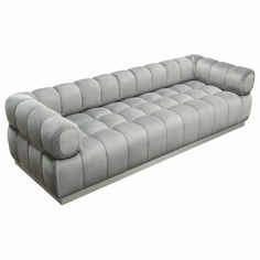 a large gray couch sitting on top of a white floor