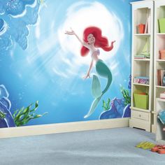 a child's room with a wall mural depicting the little mermaid