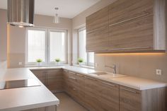 a kitchen with wooden cabinets and white counter tops