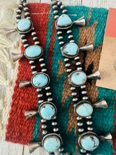 New without tags ETHNIC & REGIONAL STYLE : Native American JEWELRY TYPE : Necklaces COLOR : Blue FEATURED REFINEMENTS : Navajo Necklace MAIN STONE COLOR : Blue TRIBAL AFFILIATION : Navajo METAL : Sterling Silver MAIN STONE : Turquoise Absolutely stunning! Navajo Golden Hills Turquoise & Sterling Silver Cluster Necklace Set. This set is incredibly gorgeous! Necklace measures 24 inches long. Center pendant measures 3 inches long. Matching earrings measure 1 1/4 inches long and 5/8 of an inch wide. Handmade Western Blue Jewelry, Handmade Blue Western Jewelry, Western Style Blue Necklace For Gift, Southwestern Blue Jewelry For Wedding, Navajo Necklace, Golden Hill, Silver Necklace Set, Cluster Necklace, Western Wedding